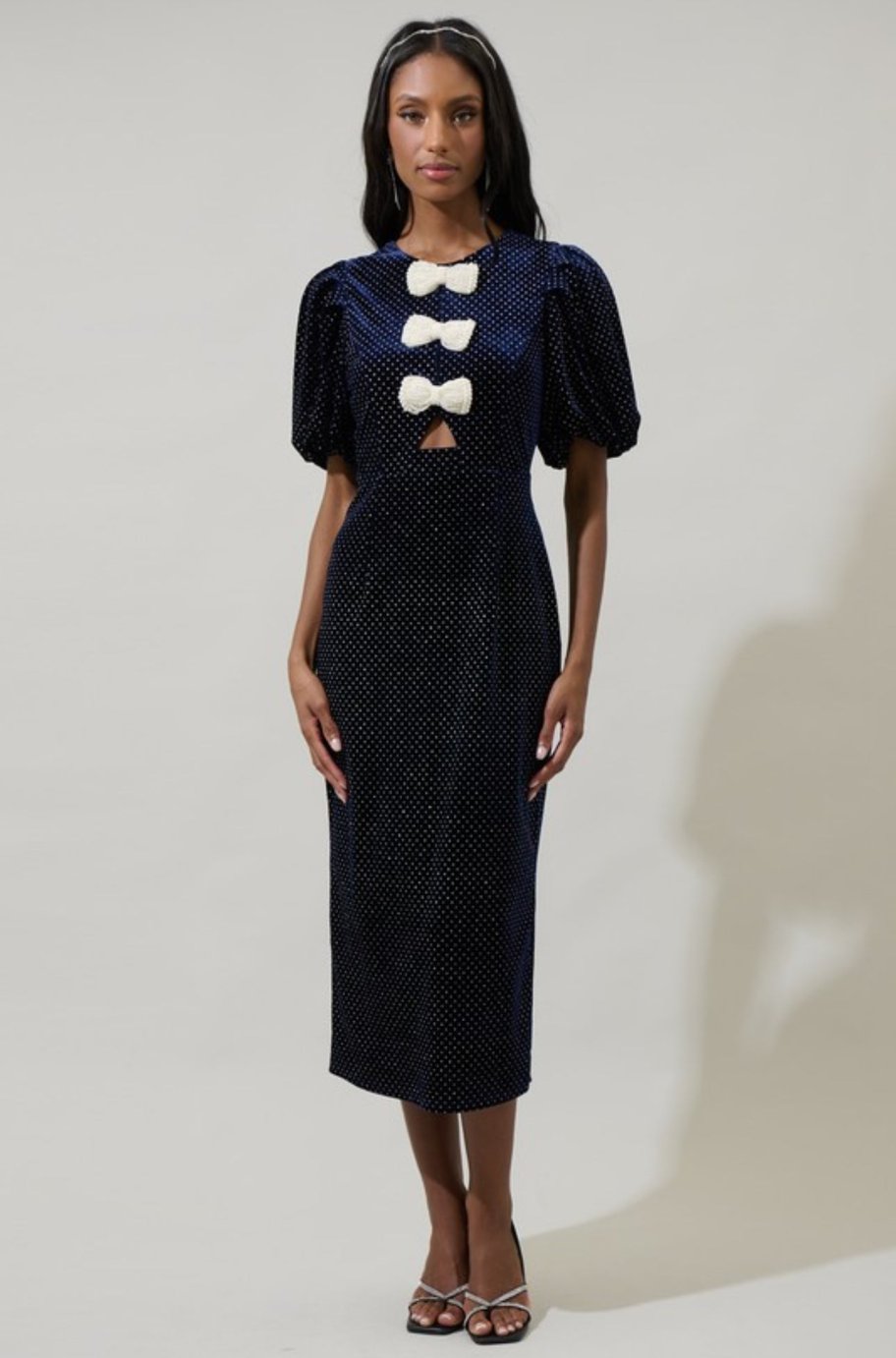 Close-up of the pearl bow sleeve detail on the Mila navy dress