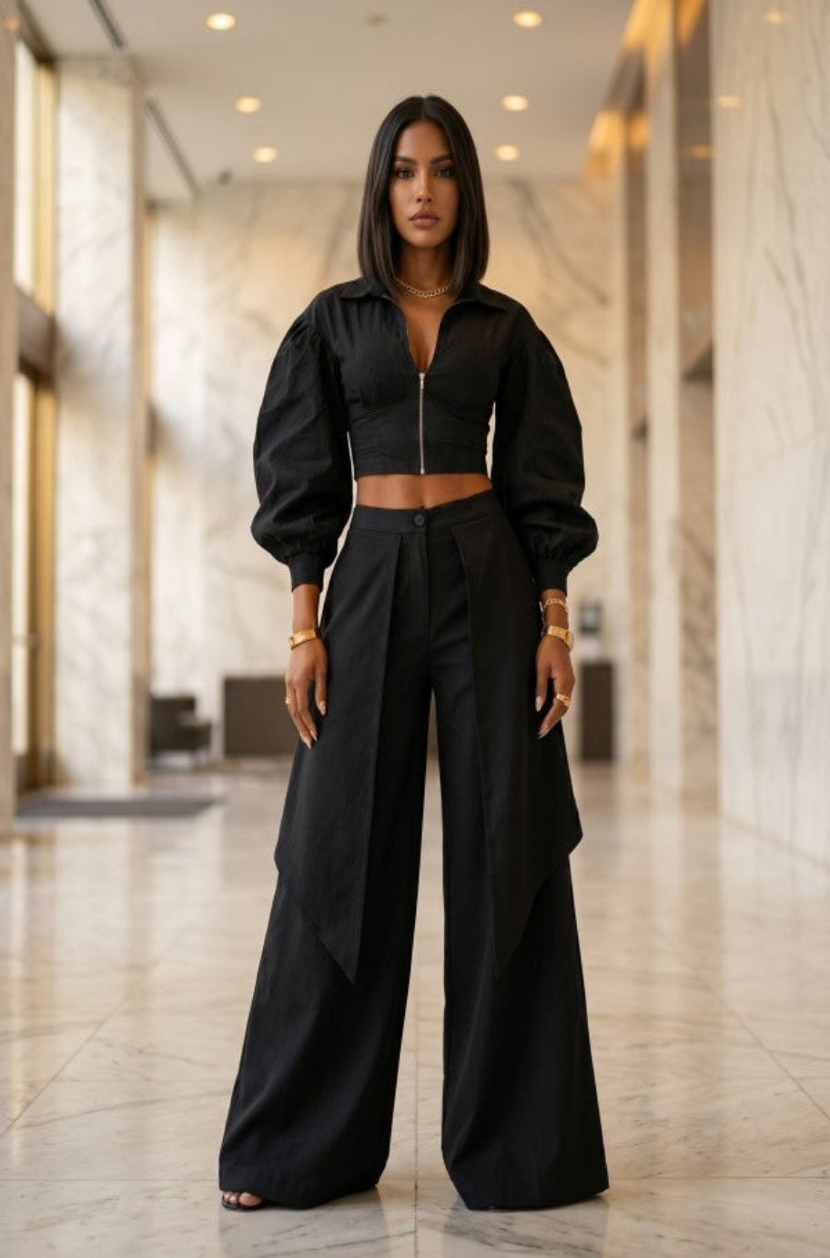 Black cropped zip-front jacket with statement sleeves and draped wide-leg trousers