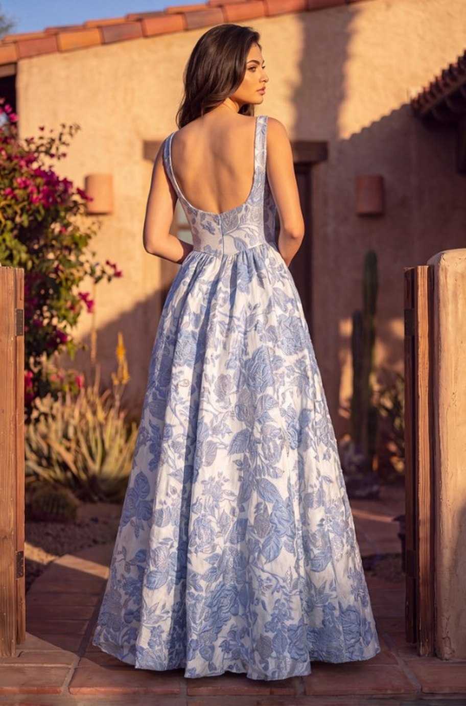 The Azzurra Gown in blue, back view - low scooped open back and gathered ball skirt