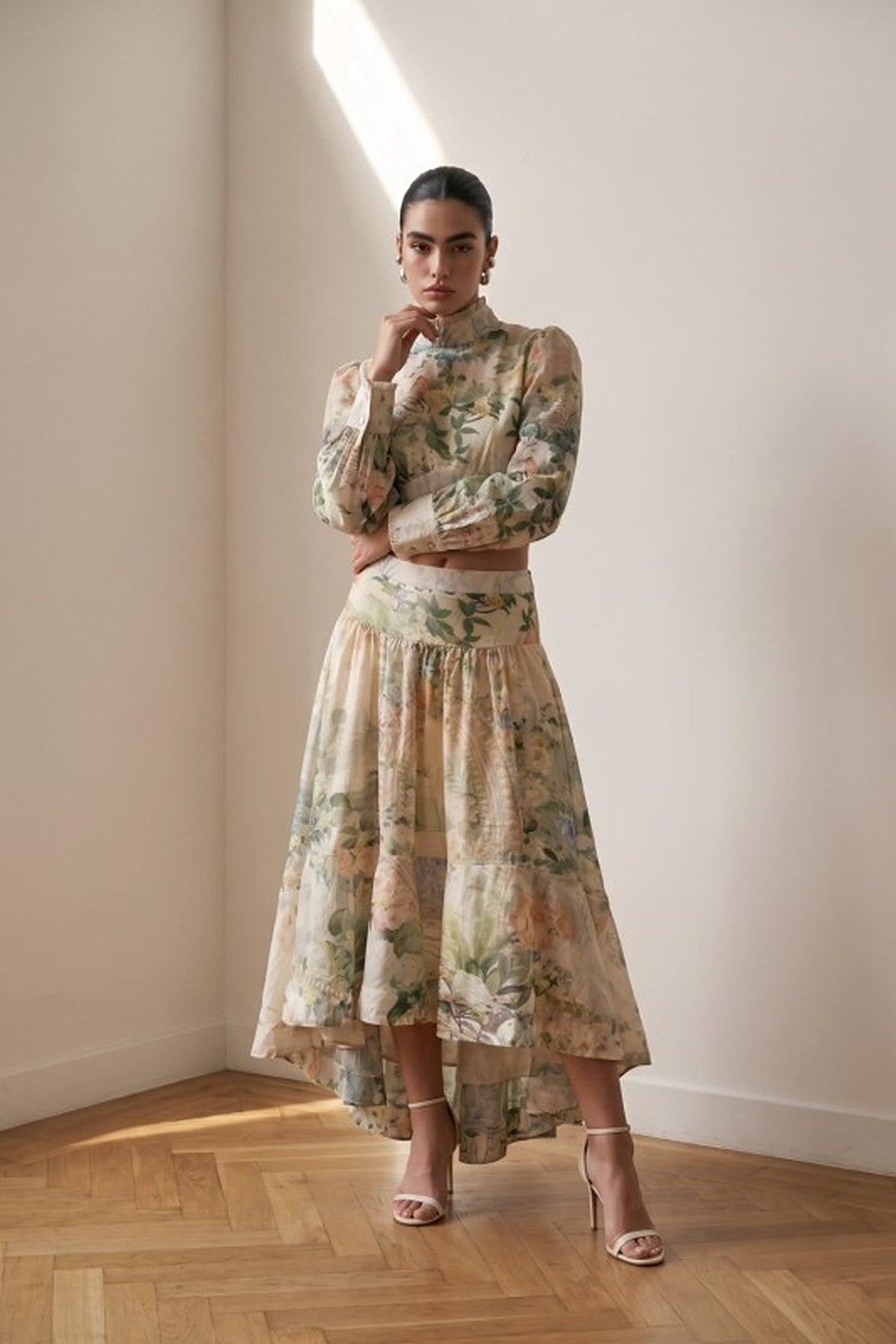 The Giardino Set, a watercolor floral two-piece with a cropped mock-neck balloon-sleeve blouse and high-low tiered maxi skirt, front view