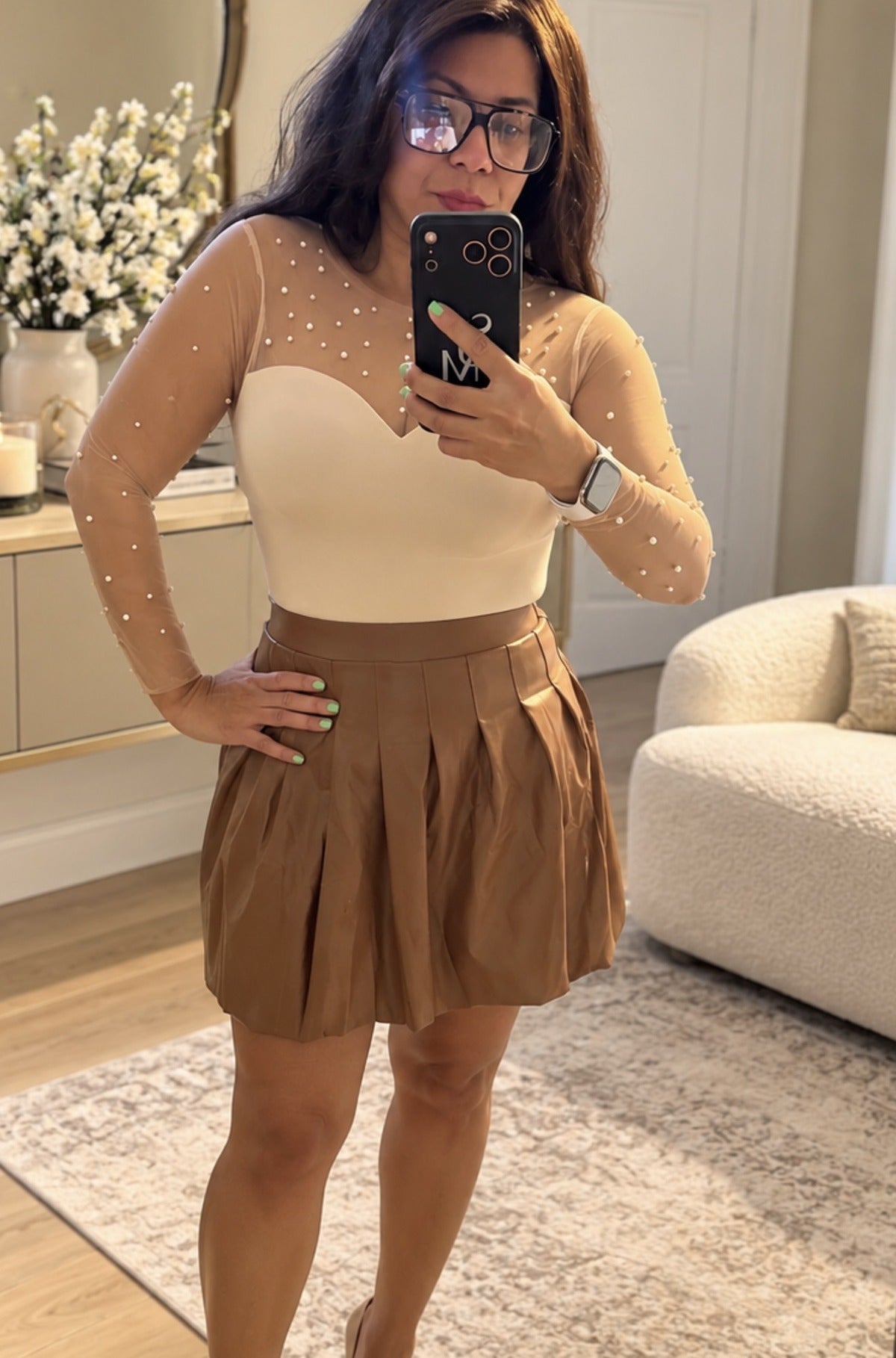 Pearl Sweetheart Bodysuit worn with a camel pleated mini skirt, front view showing the sweetheart neckline and pearl mesh sleeves