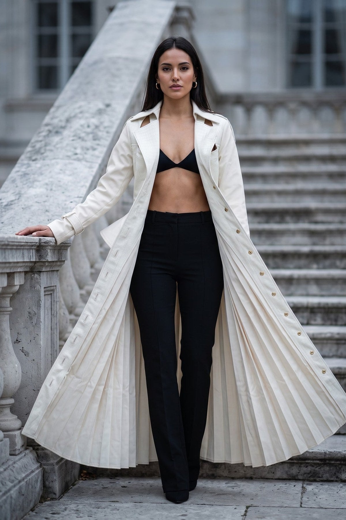 The Scala Corset Coat worn open as a full-length coat over black trousers, pleats sweeping out to the floor