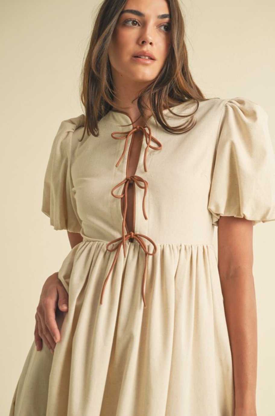 Close-up of the bow tie shoulder detail on the Casani midi dress