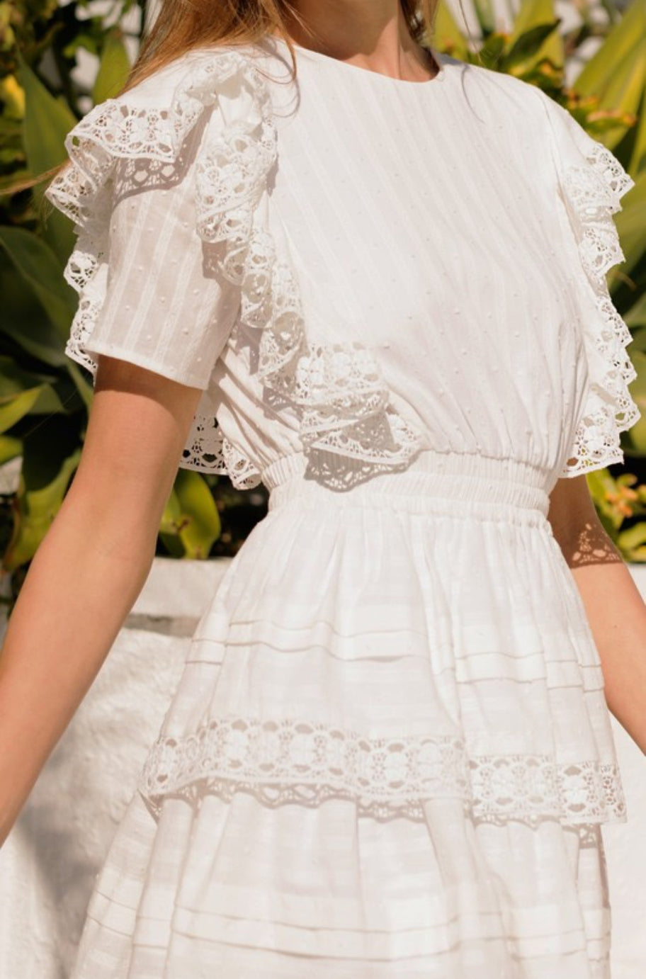 Close-up of the crochet lace trim on the Vana white dress