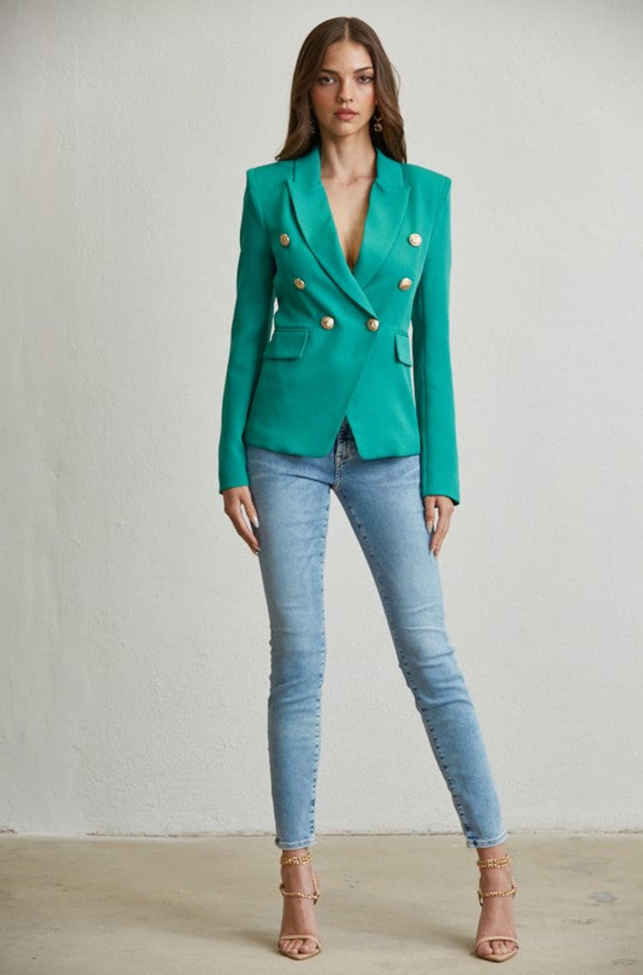 Emerald green double-breasted blazer with gold buttons