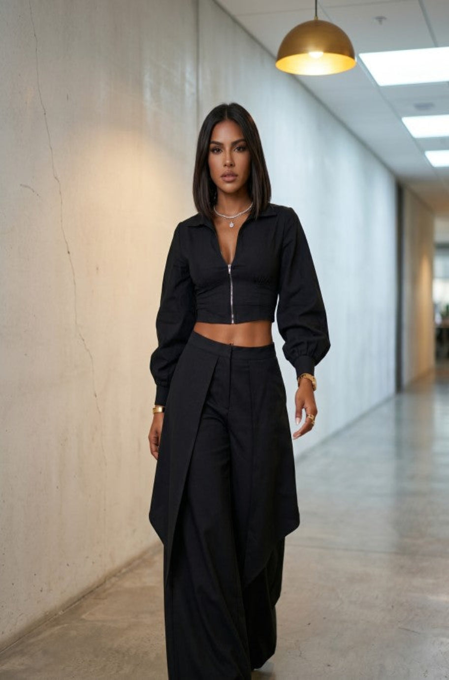 Close-up of the asymmetrical overlay on the Noir Nomad trousers