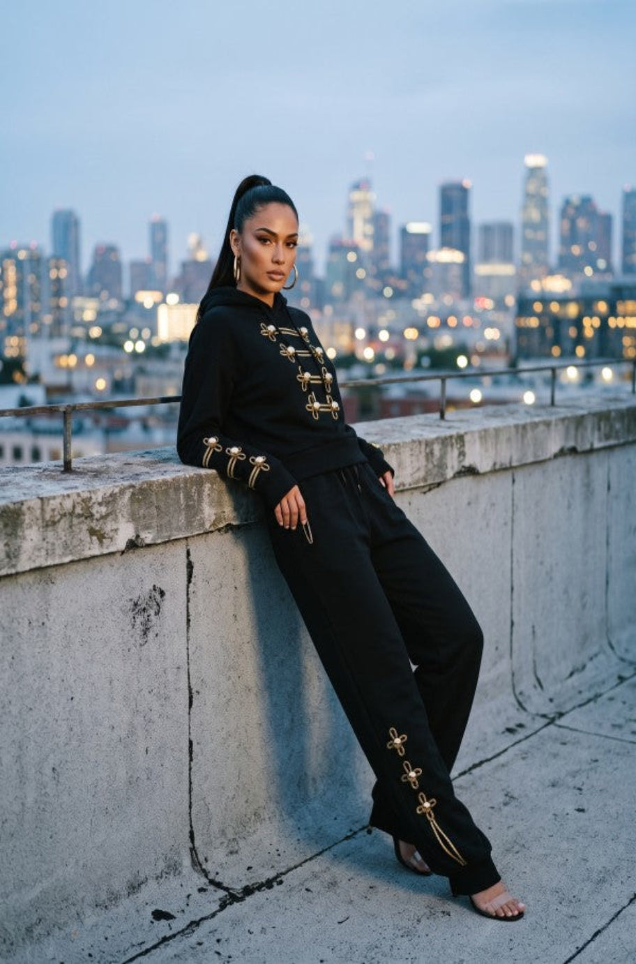 Black hoodie and trouser set with ornate gold military-style detailing