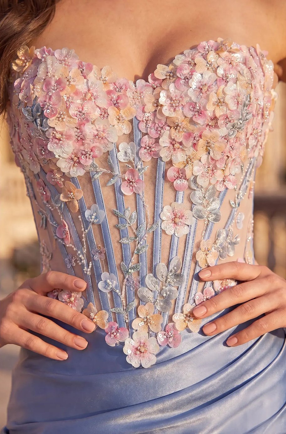Close-up of the Riviera Mini Dress corset bodice with dimensional pink and cream flowers, pearl beading and silver embroidered leaves