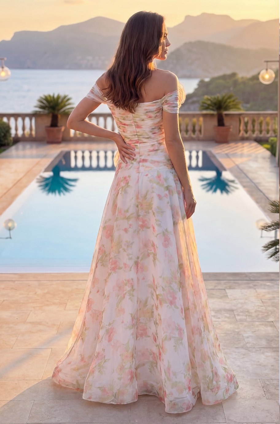 Back view of the Rosalia Gown — off-the-shoulder sleeves and full floral maxi skirt at golden hour