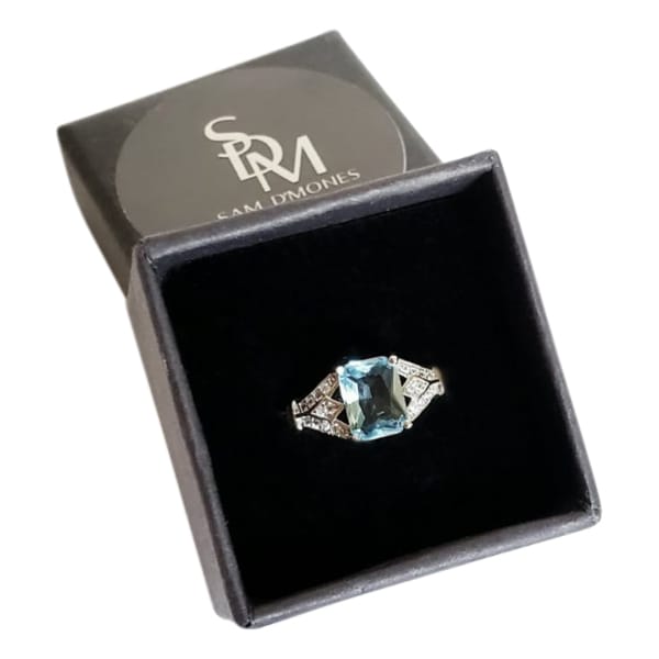Silver ring with sea blue princess cut stone