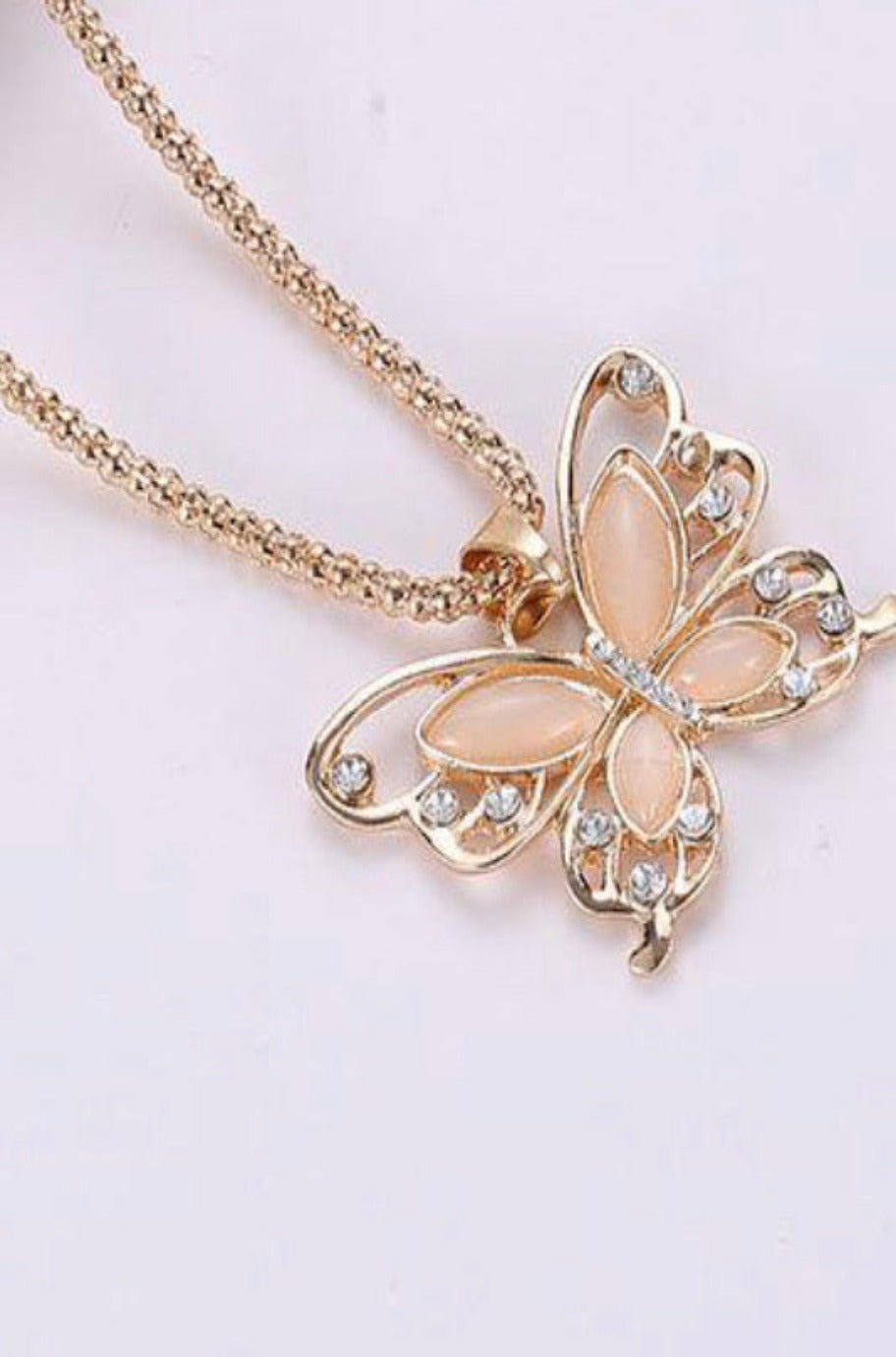 Rose gold butterfly necklace, detail view