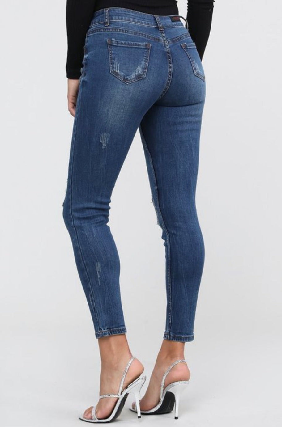 Distressed mid-waist jeans, back view